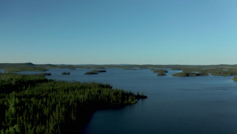 aerial shot over a blue and wild lake in northern quebec province in canada