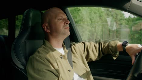 man drinking water while driving