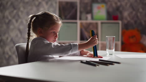 funny child takes bunch of colorful pencils to draw picture
