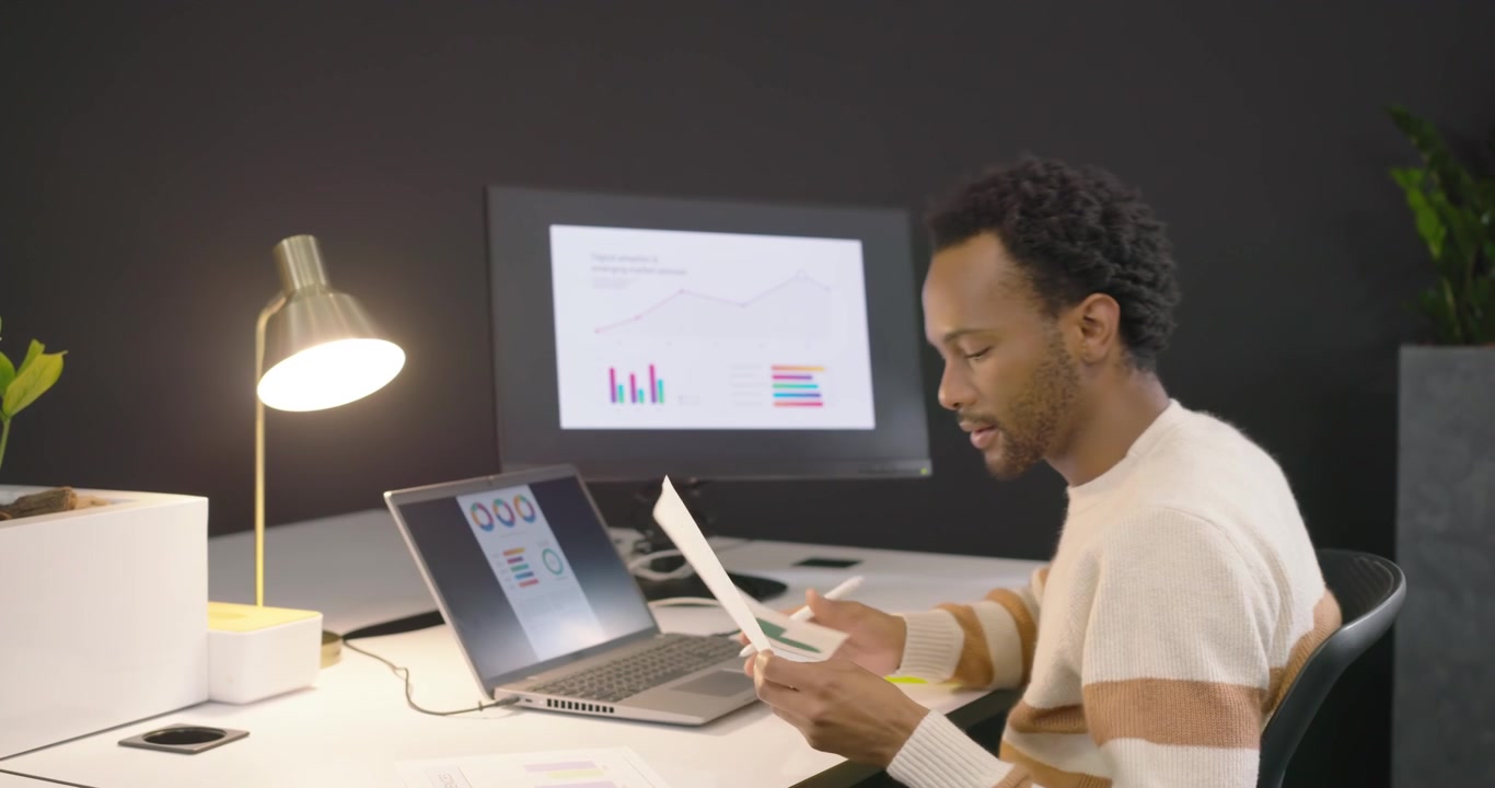 Young Professional Analyzing Financial Data in Modern Office