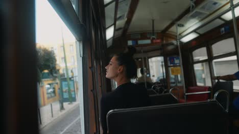 woman riding a tram in the city