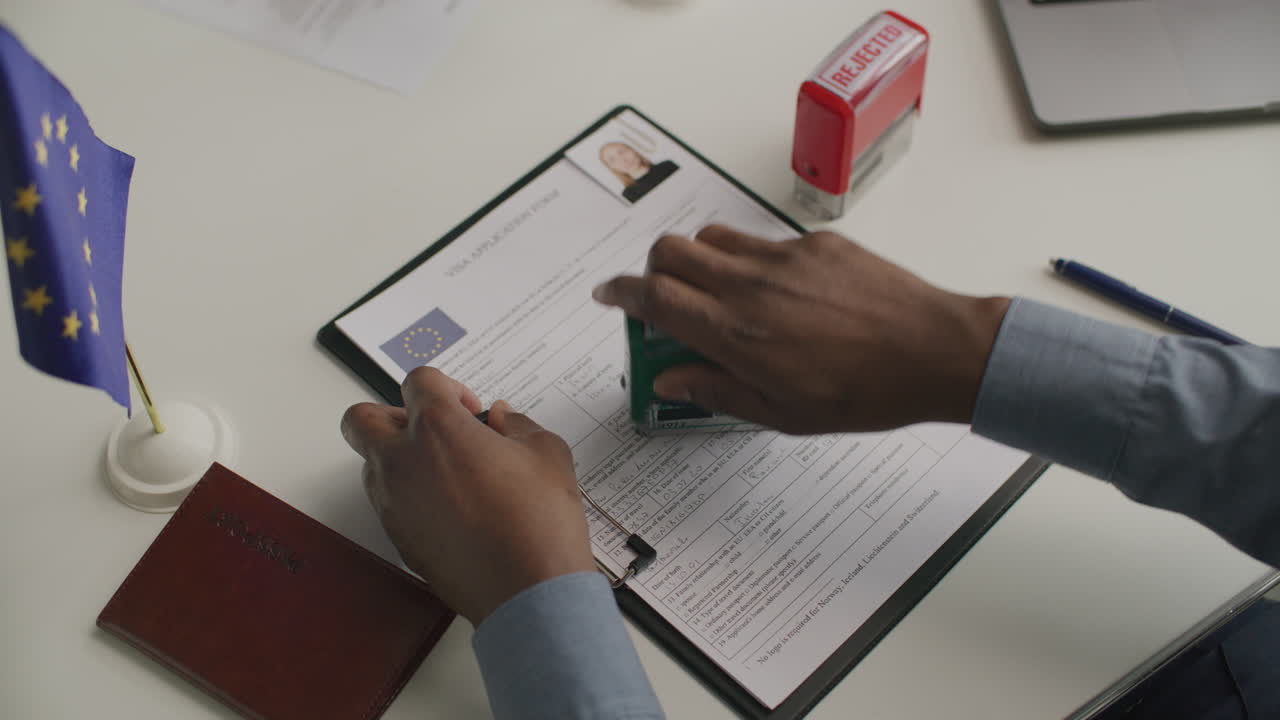 Close-Up of Consular Officer Stamping Approval on European Visa Application