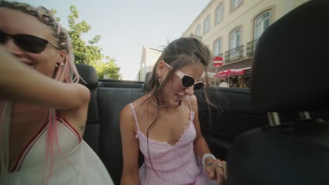 two women having fun in a convertible
