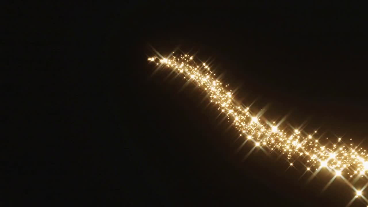 Emisor activándose, rastro de partículas doradas moviéndose hacia dentro y formando el contorno de un corazón, destellos de estrellas