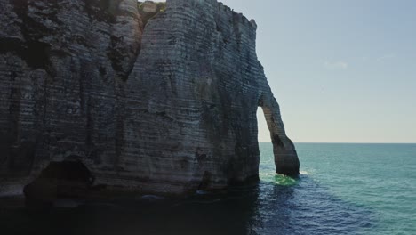 coastal cliffs and natural arch at etretat, france