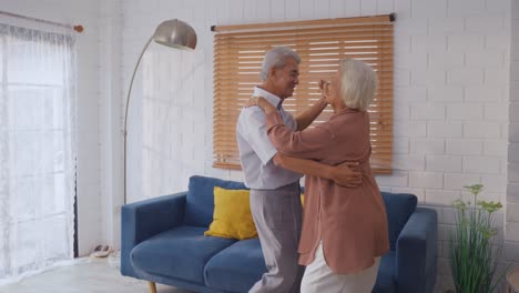 elderly couple dancing at home