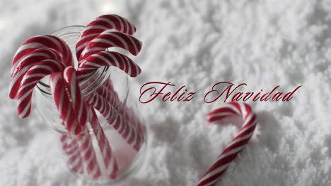 Texto-De-Feliz-Navidad-Con-Bastones-De-Caramelo-De-Navidad-Sobre-Fondo-De-Nieve