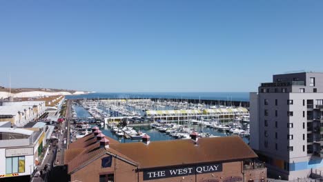 aerial reveal of brighton marina, west quay, boardwalk and white cliffs on a sunny day