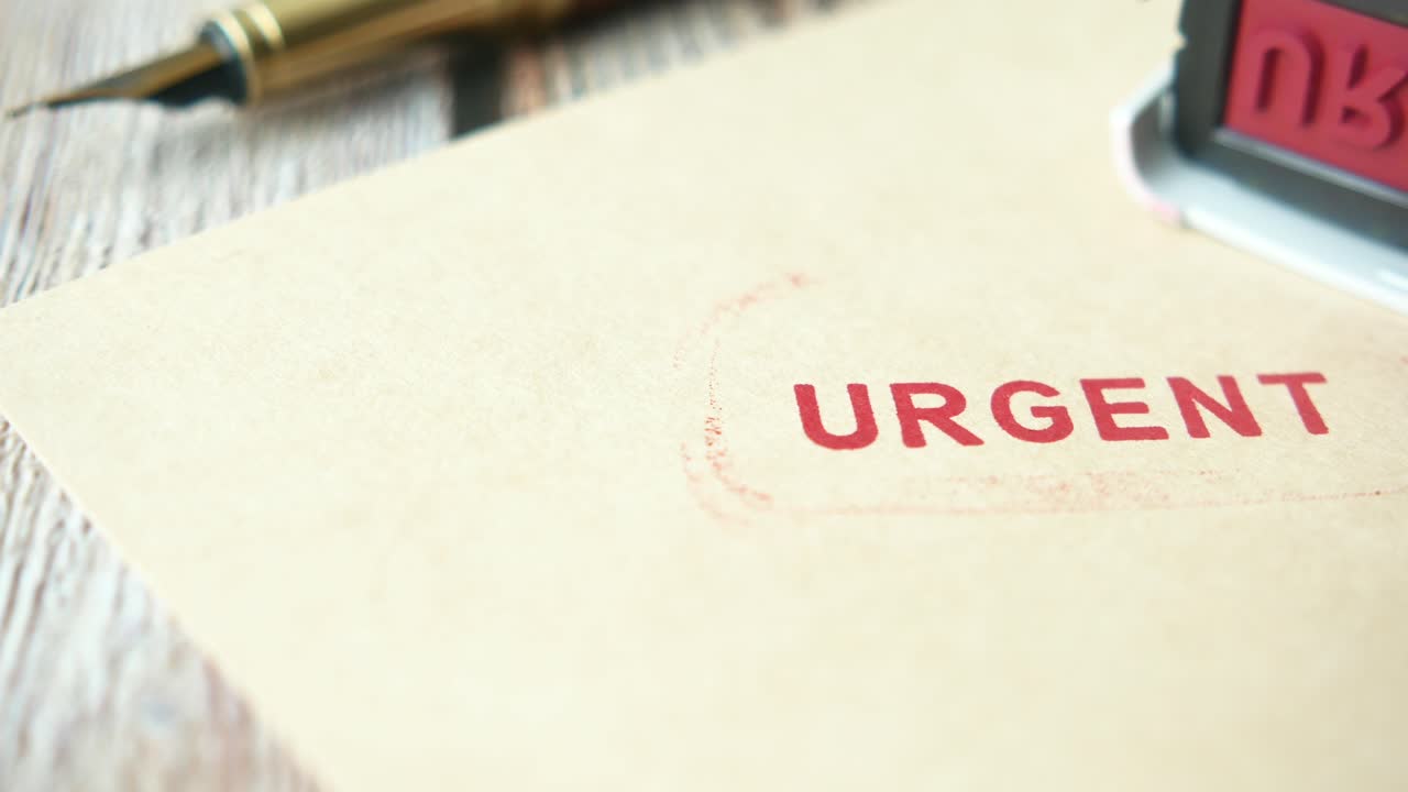 Red Urgent Stamp on a Piece of Paper