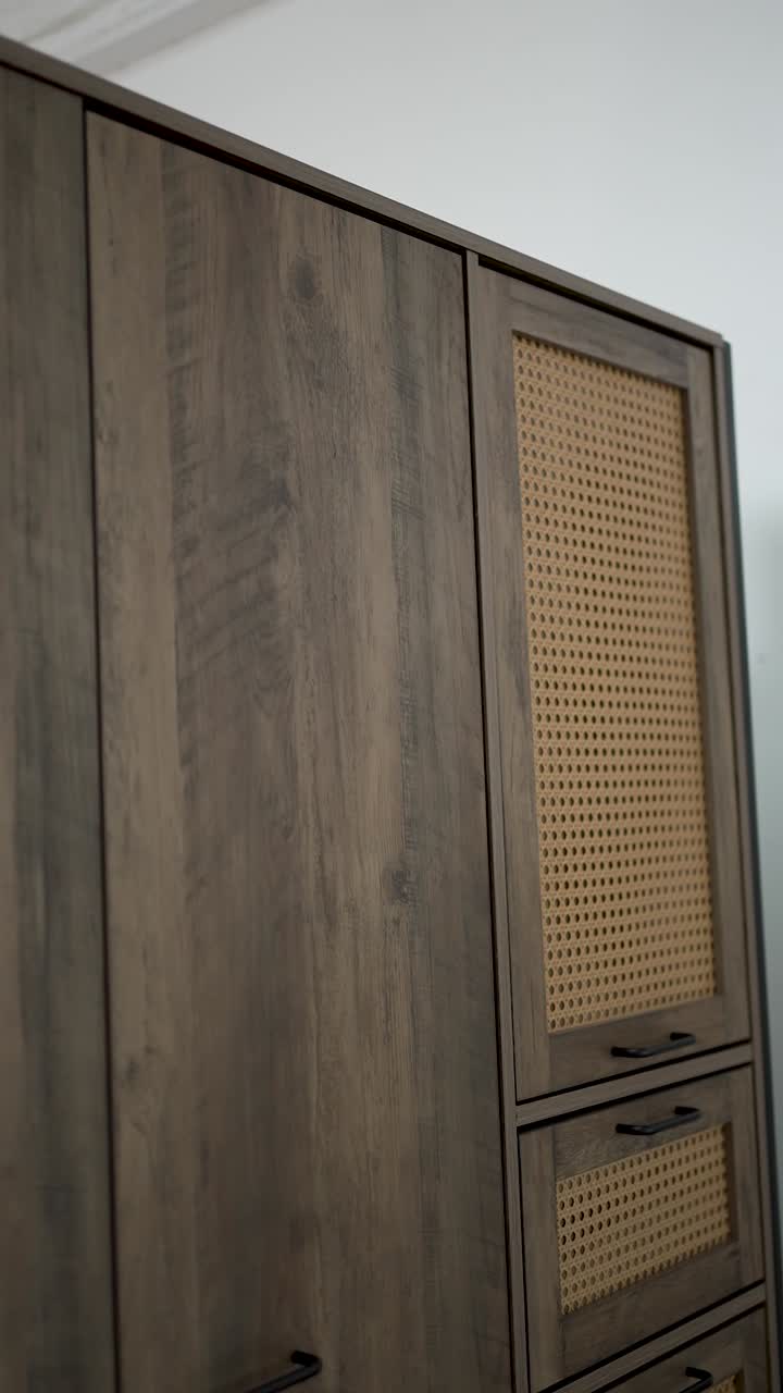 A beautiful wooden cabinet features a chic cane panel design, blending functionality and style in a contemporary room. The natural finish highlights its elegance and charm