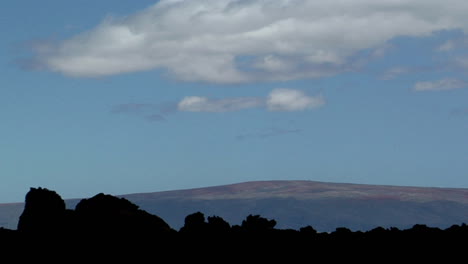 A-Low-Lying-Volcano-Is-Seen-Behind-A-Black-Lava-Flow