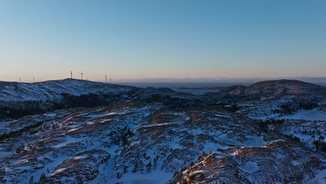 mountain landscape and windmills in bessaker, norway - aerial drone shot