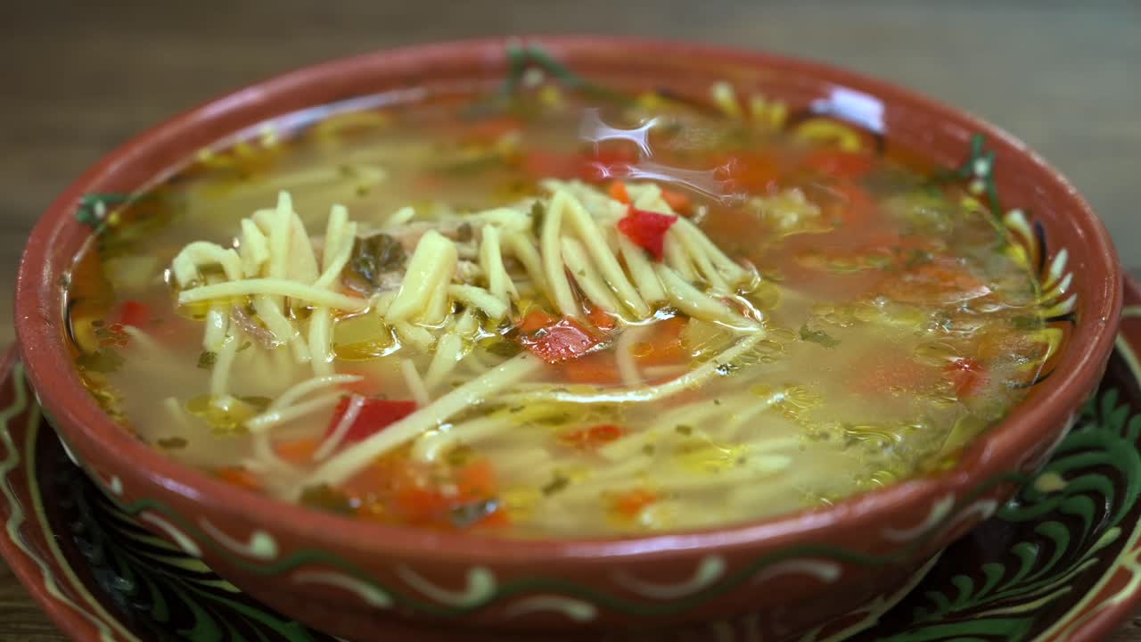 Close up of a bowl of eastern European chicken noodle soup