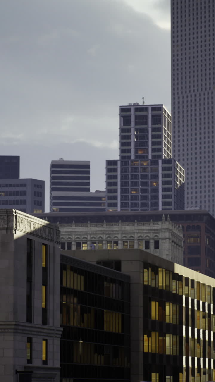 Urban skyline illuminated by soft evening light with historic water tower