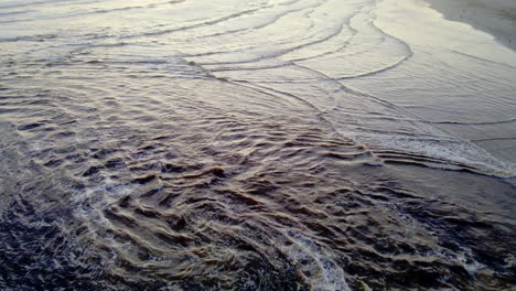 Klein-River-lagoon-breaching-sandbar-on-Grotto-beach,-Hermanus