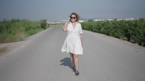 woman walking down a country road