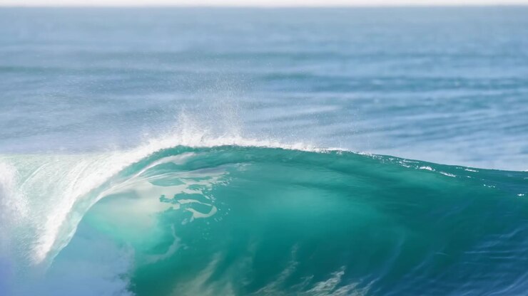 Turquoise Barrel Wave Breaking Over Ocean, Cinematic Slow Motion Capture Of Sunlight Glinting Off Crest, Spray