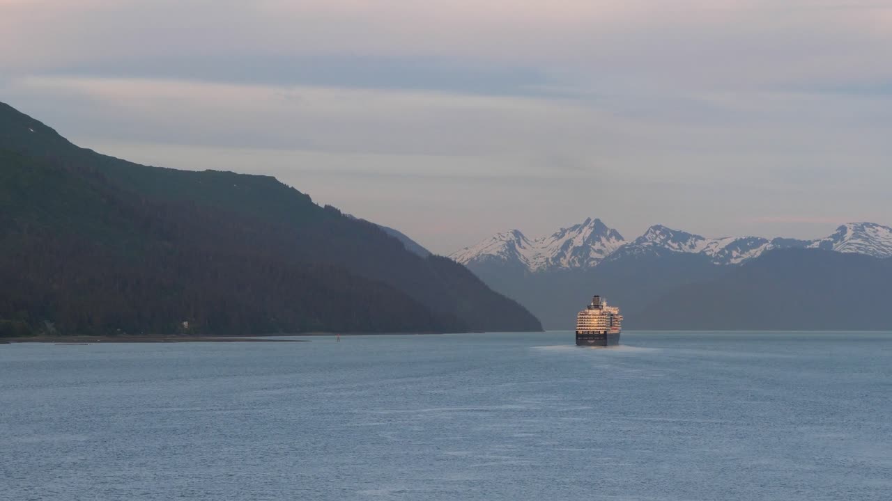 Cruise liner sailing at sunset from Juneau, Alaska, on Gastineau Channel.