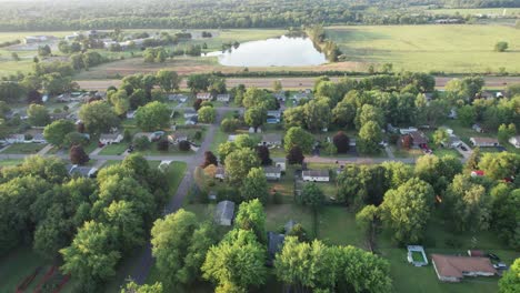 an aerial shot of residential neighborhood near grassy park and beautiful lakes