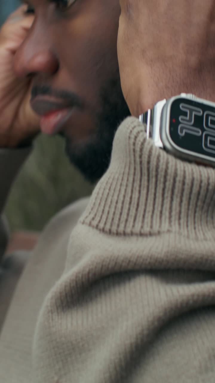 Man wearing a watch and earbuds