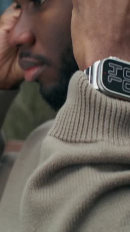 man wearing a watch and earbuds