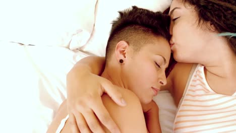 happy lesbian couple on bed