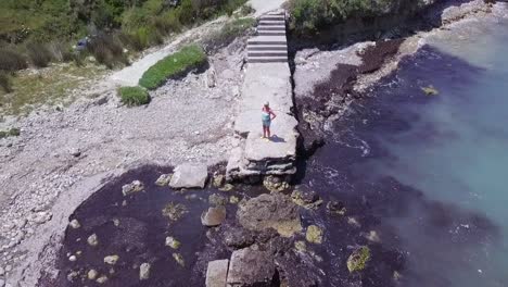 Aerial-drone-view-of-women-admiring-seaview-in-Corfu-Greek-island-during-summer