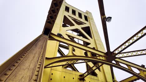 High-quality-4K-shot-looking-up-at-the-Yellow-Tower-Bridge-in-downtown-Sacramento-with-an-empty-grey-sky-in-the-background