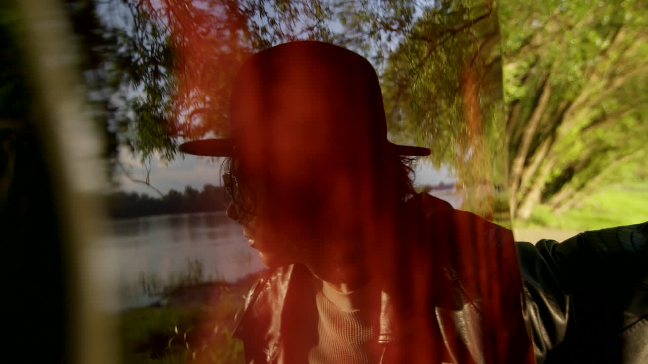 Person in park by a river with reflection