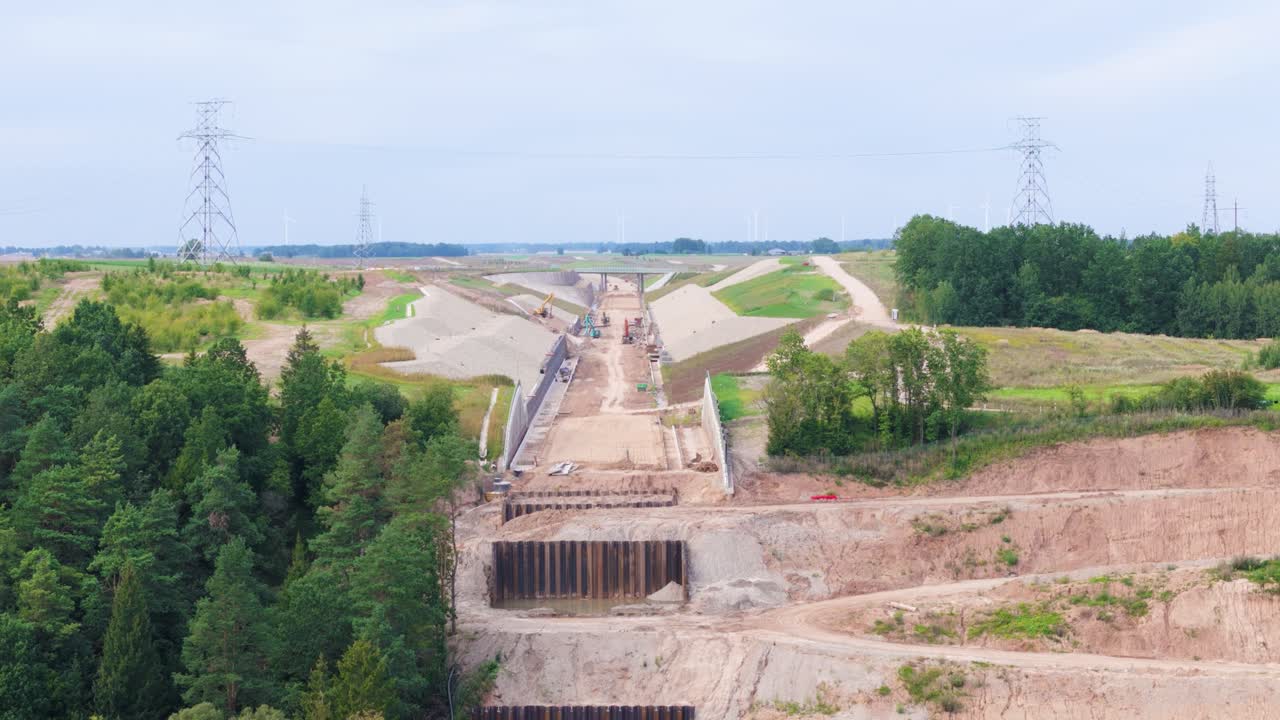 Road construction site with earthworks and overpass