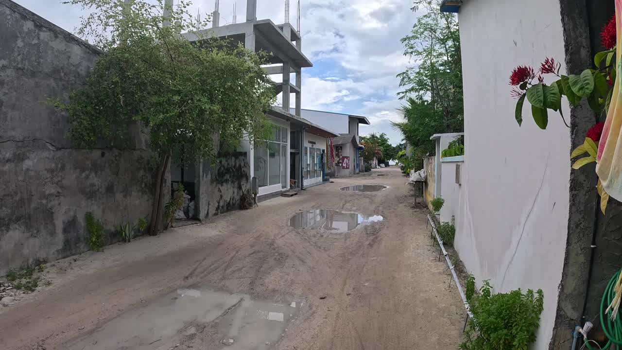 A dirt road in a Maldivian village