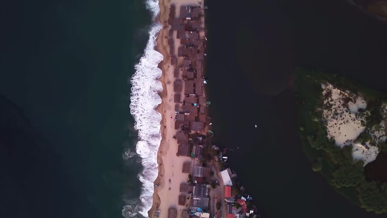 Aerial birds eye top down view of Acapulco beach village coast at day