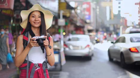 the young chinese traveler take a photo in china town of thailand.