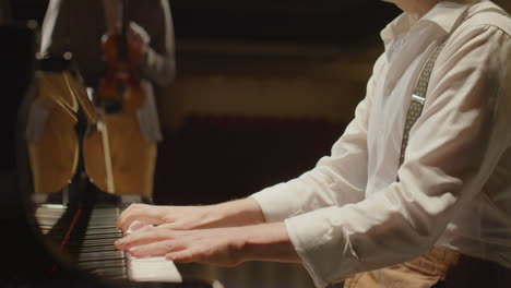 classical musicians playing piano and violin on stage