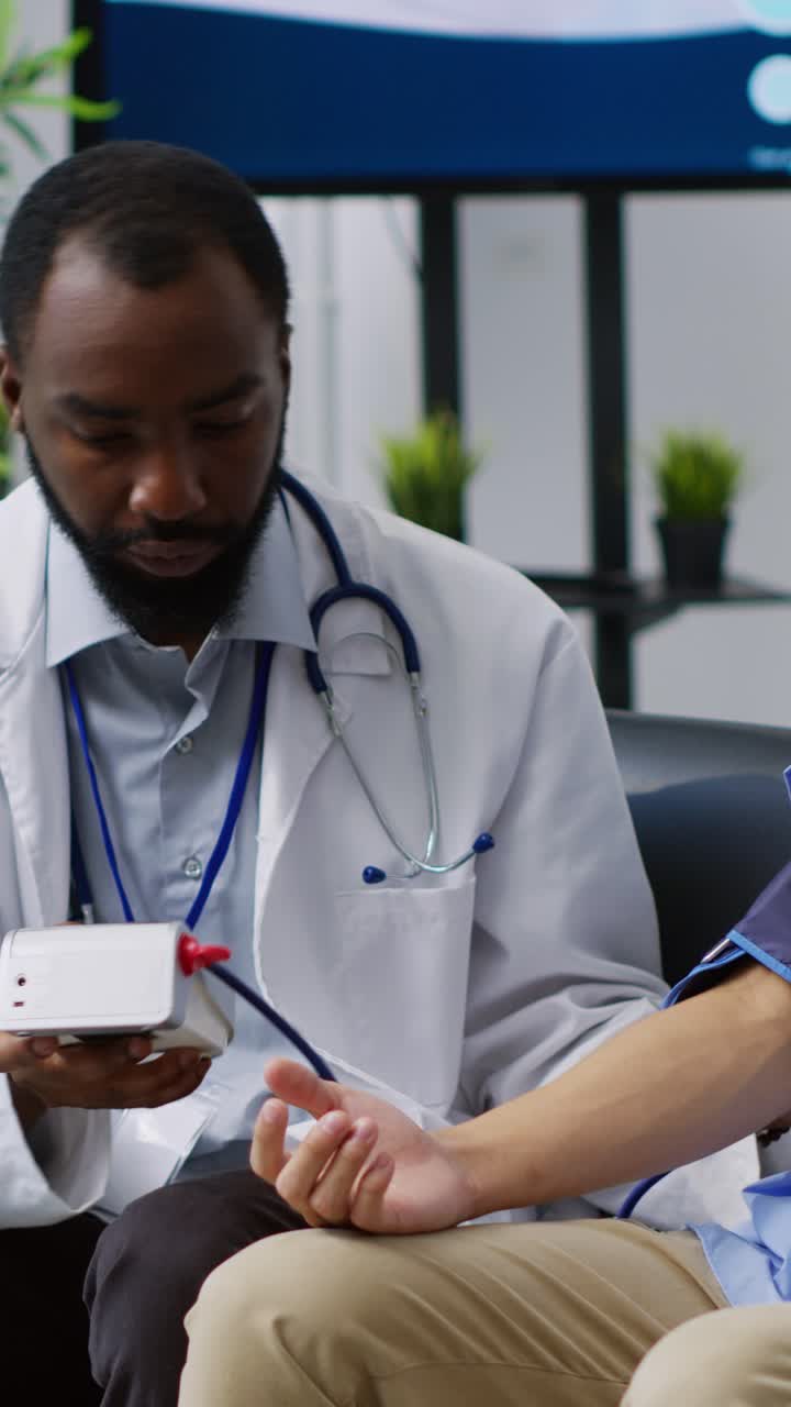 Vertical video: Cardiologist using tonometer instrument
