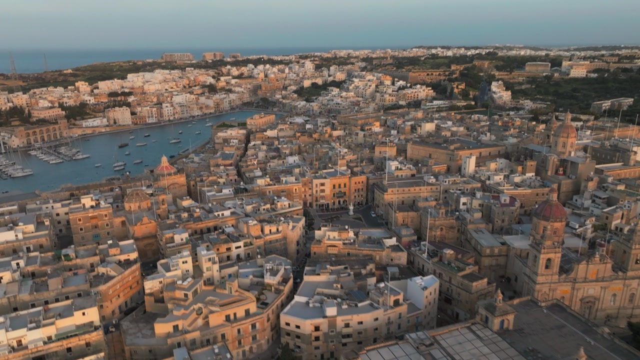 Birgu Waterfront In Malta At Dusk With Kalkara Creek Revealed. aerial tilt-up shot