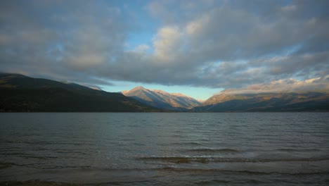 Shore-of-Twin-Lakes-Reservoir-in-Colorado-watching-the-sun-reveal-the-Rocky-Mountains,-Static