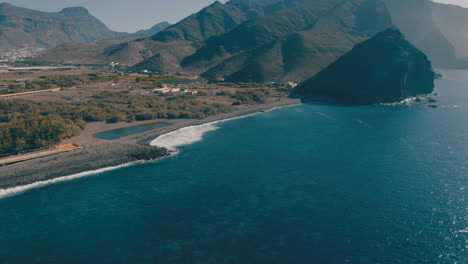 Orbital-aerial-view-of-the-puddle-and-the-beach-of-the-Village-of-San-Nicolas-on-a-sunny-day