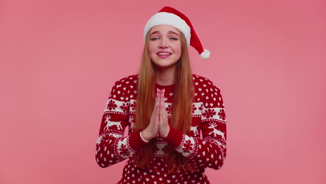 Girl-in-Christmas-Santa-sweater-praying,-looking-upward,-making-wish,-asking-with-hopeful-expression