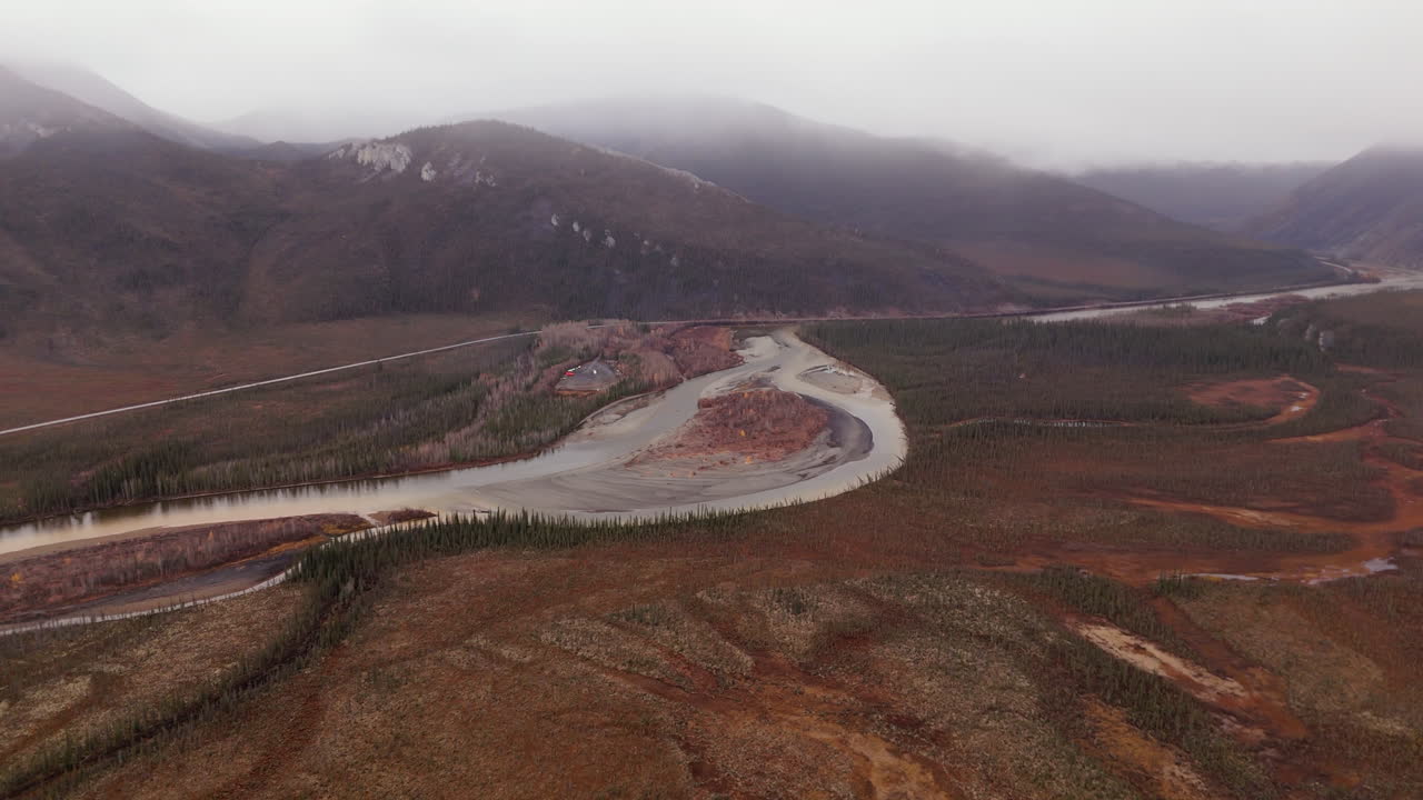 Meandering River Through Autumn Landscape Of Ogilvie Mountains In Yukon, Canada. aerial shot