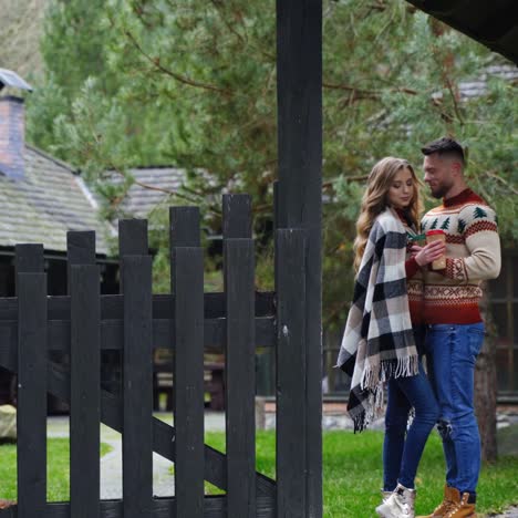 young couple in love outdoors. date of happy couple at front yard in autumn. man and a lovely girlfriend spending romantic time outside in village.