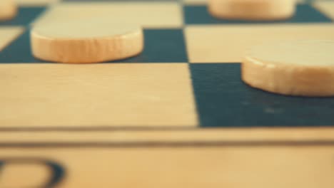 pan macro close up shot of a wooden board of a draughts checkers strategy game, 4k