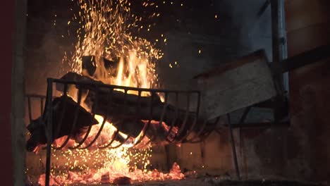 close shot of the fire, an artisan preparing wood on the side of barbecue grill