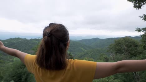 Woman's-head-zooms-out-from-her-left-side-to-reveal-her-stands-stretched-out-suggesting-her-joy-of-being-with-nature