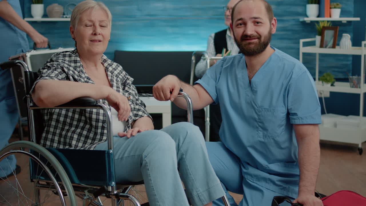 Portrait of senior woman in wheelchair and man nurse