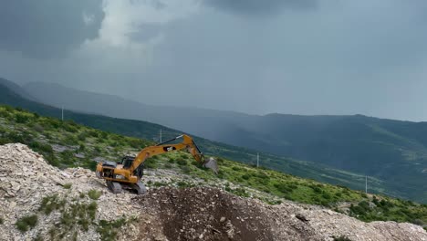 excavator on mountain top digging and clearing for a quarry causing erosion and pollution