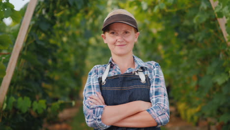 portrait of a farmer woman near a manicured vineyard small business owner