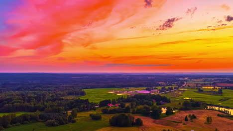 vivid magenta sky over fields and rolling hills at dusk, smooth cloud texture reflects across sky and forest