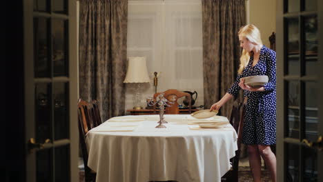 a woman serves a table in a jut home dining room