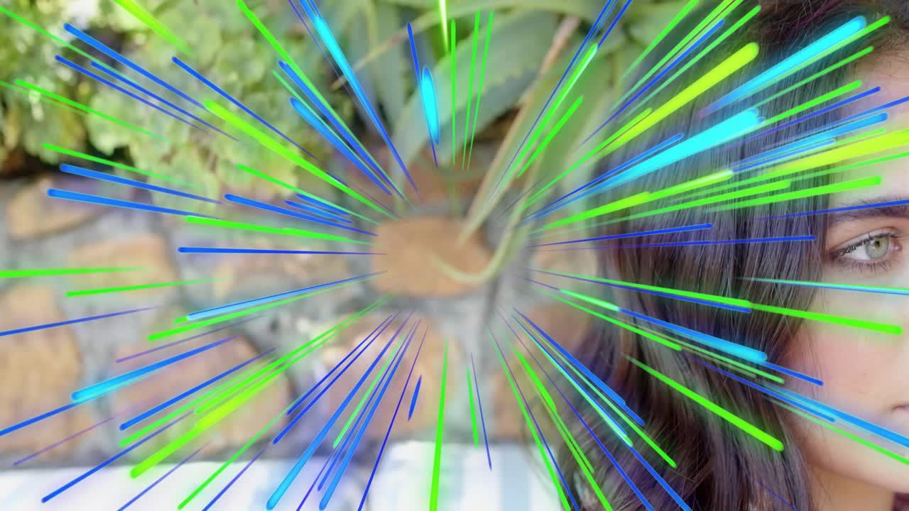 Woman posing right of frame, radial burst starting, revealing eye against brick wall plant for tech